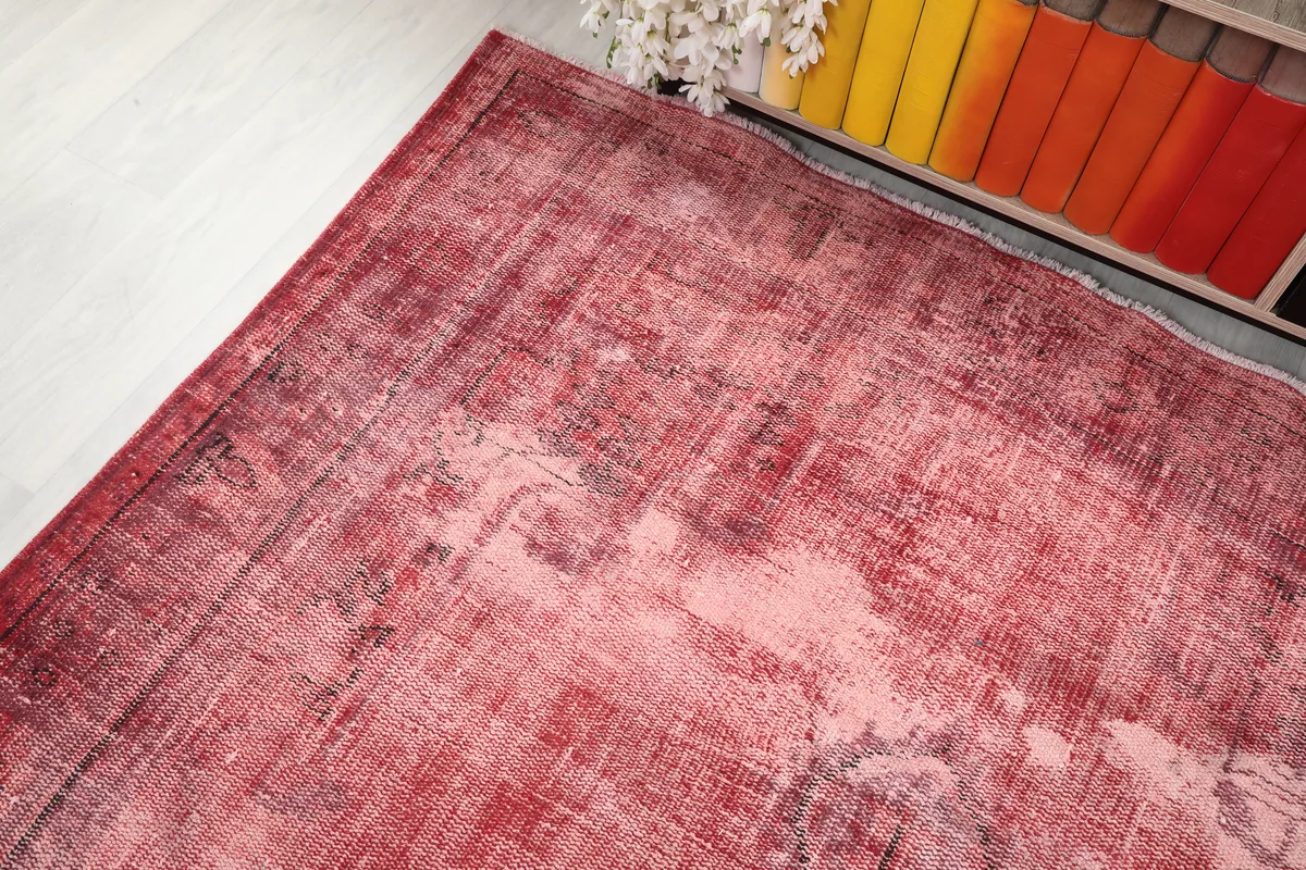 Another angle of the Faded Rose Geometric Vintage Rug, highlighting its distressed surface.