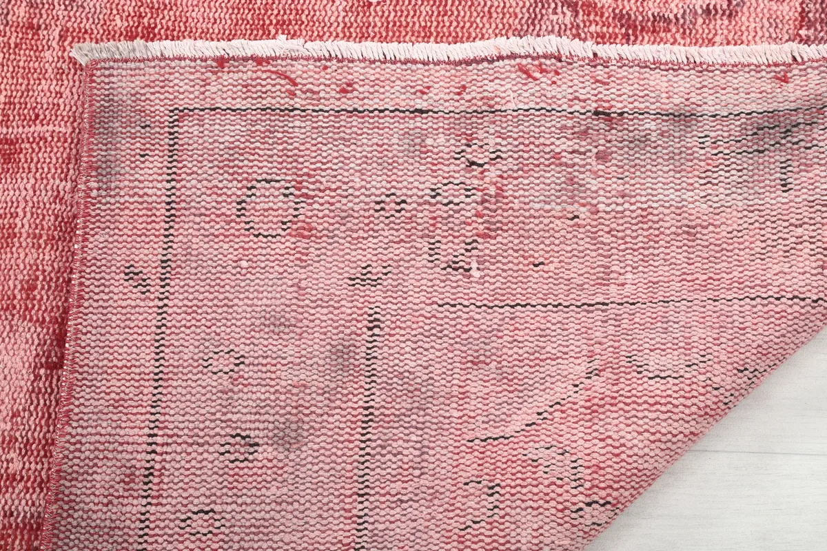Close-up of the back of the Faded Rose Geometric Vintage Rug, revealing the hand-knotted construction.