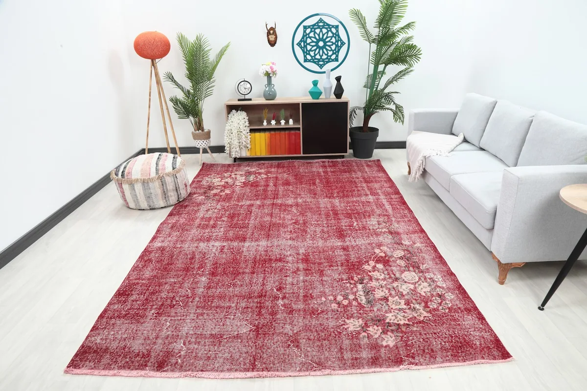 Rose floral rug displayed in a living room setting with a light gray sofa