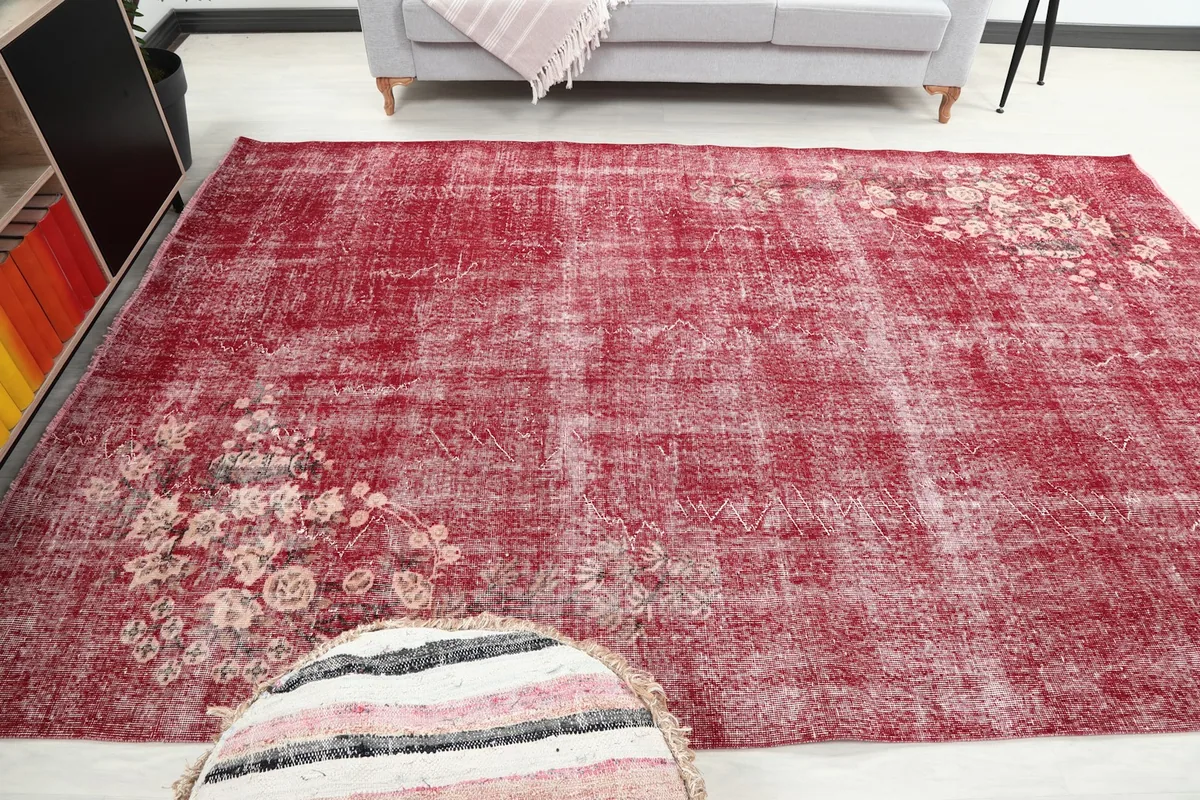 Rose vintage rug in a wider room view, showcasing its large size and floral details