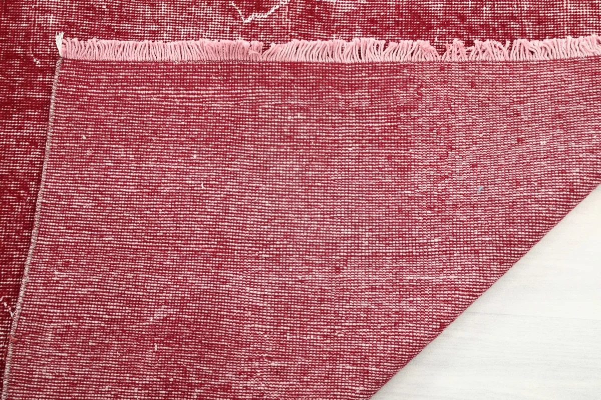 Close-up of the back of the rose rug, revealing the tight hand-knotted weave and fringe