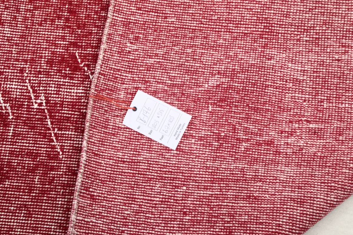 Rug tag on the back of the rose vintage rug, showing product information