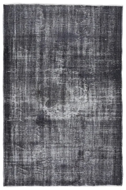 Full overhead view of the charcoal distressed vintage Anatolian rug on a white background