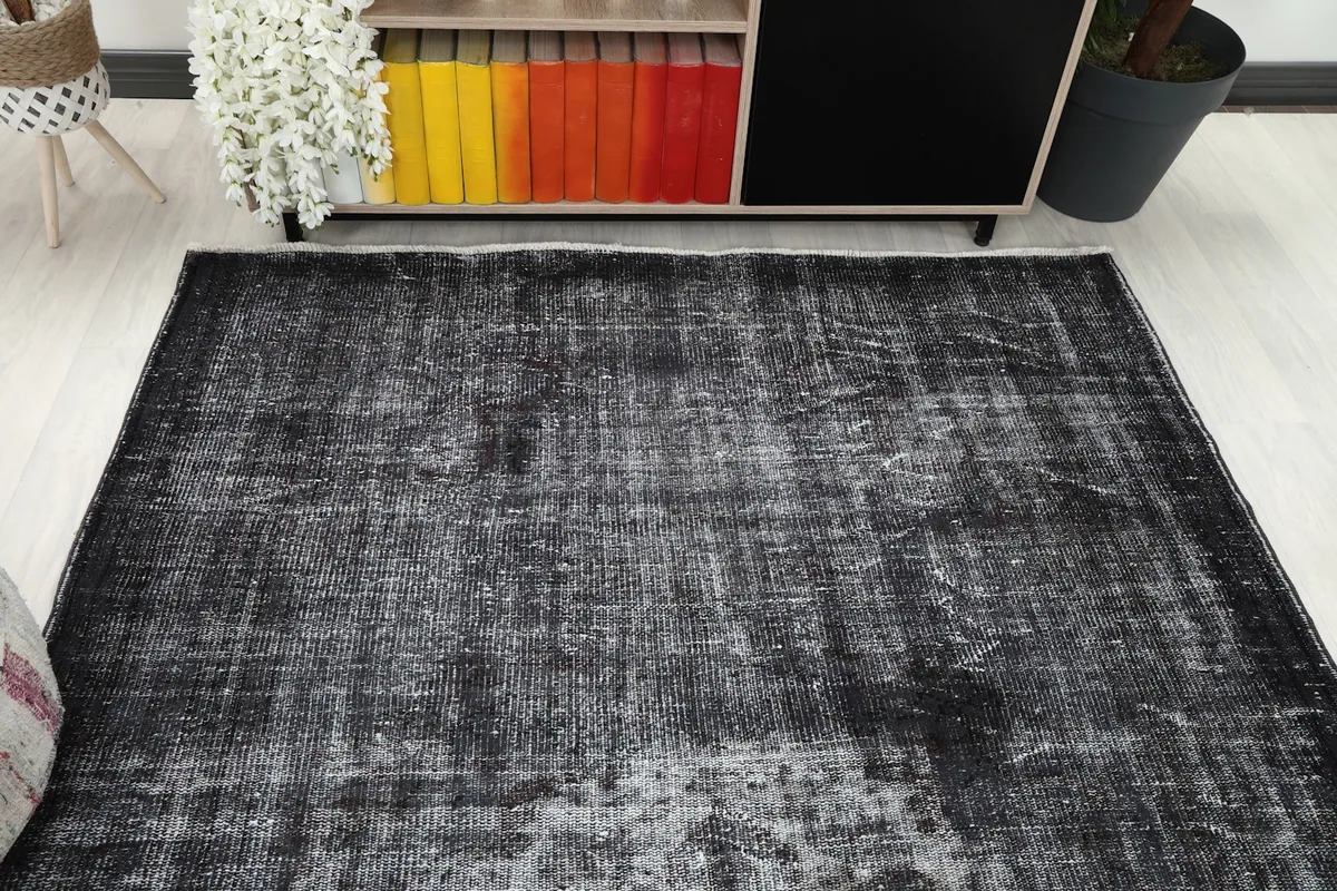 Overhead view of the charcoal rug in a room, positioned under a console table