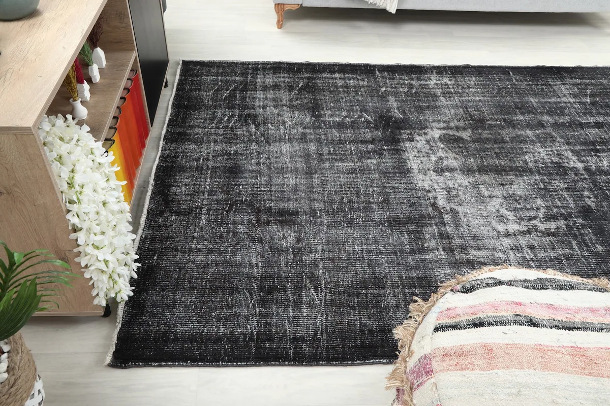 Charcoal distressed rug in a wider room shot, showing its length and proportion