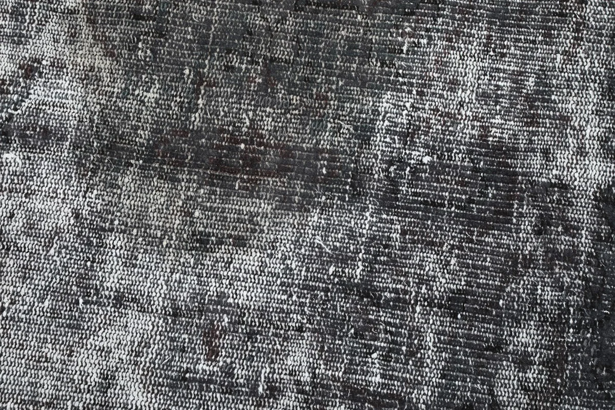Close-up of the low wool pile, showing the hand-knotted texture and distressed appearance