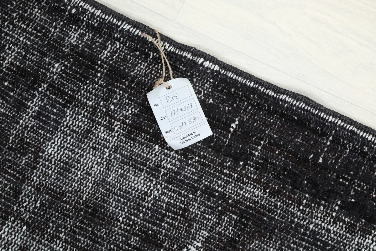 Product tag attached to the rug, displaying size and origin details