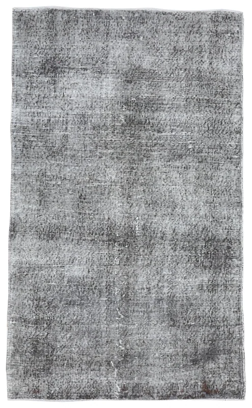 Full overhead view of the charcoal vintage Anatolian area rug on a white background