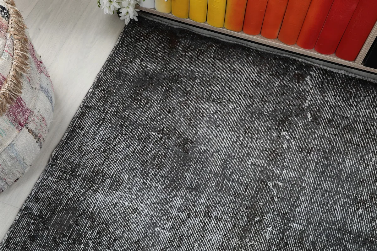 Corner view of the rug, illustrating its distressed pattern and subtle variations