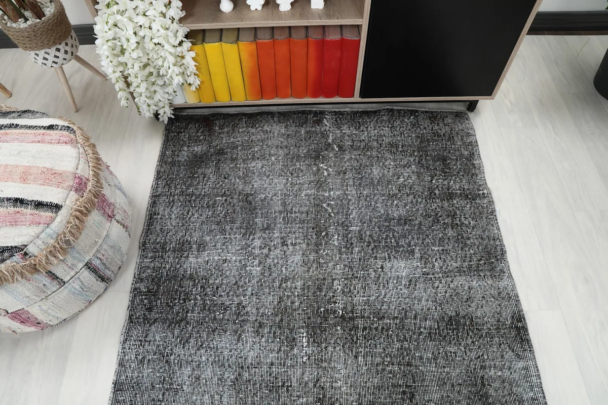 Overhead shot of the charcoal rug, showing its rectangular shape and overall appearance