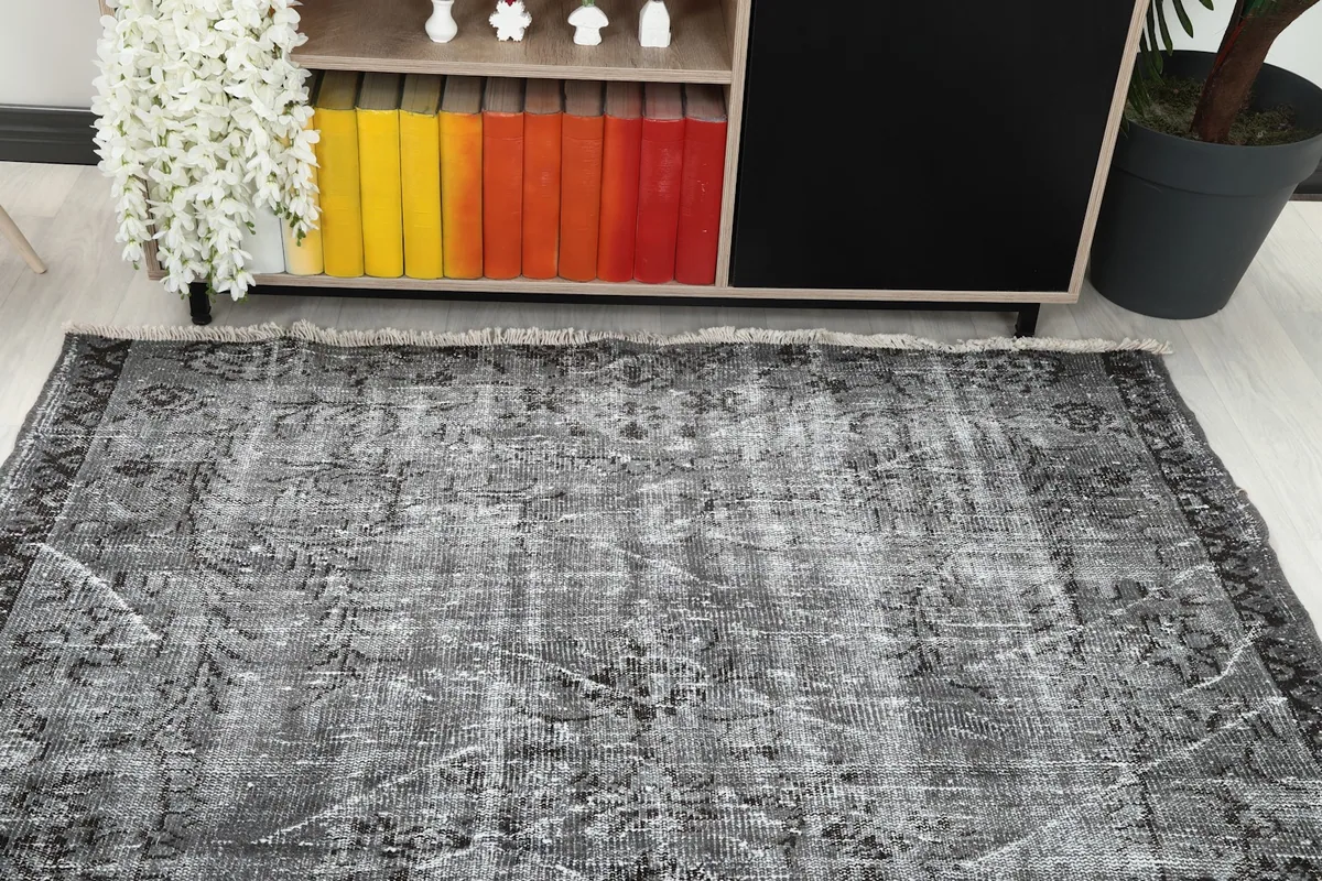 Overhead view of the vintage rug in a living room setup with a console table