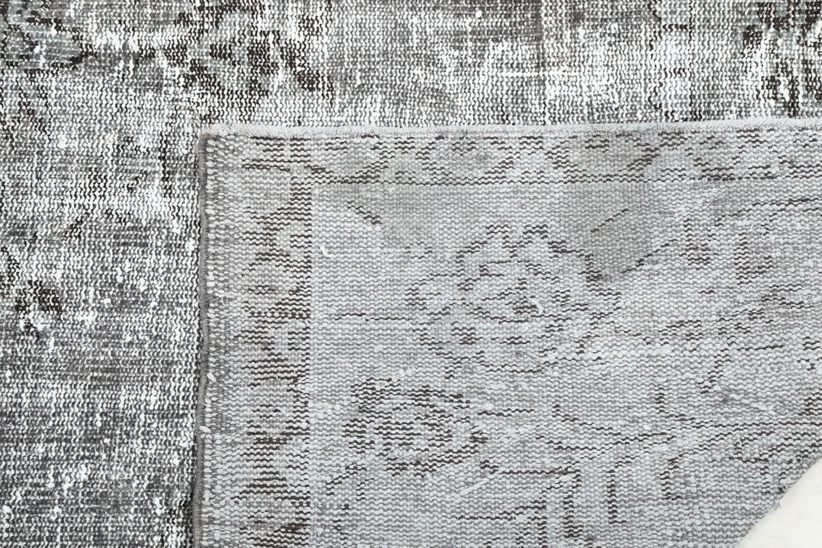 Close-up of the rug's underside and top surface, revealing the density of the knots