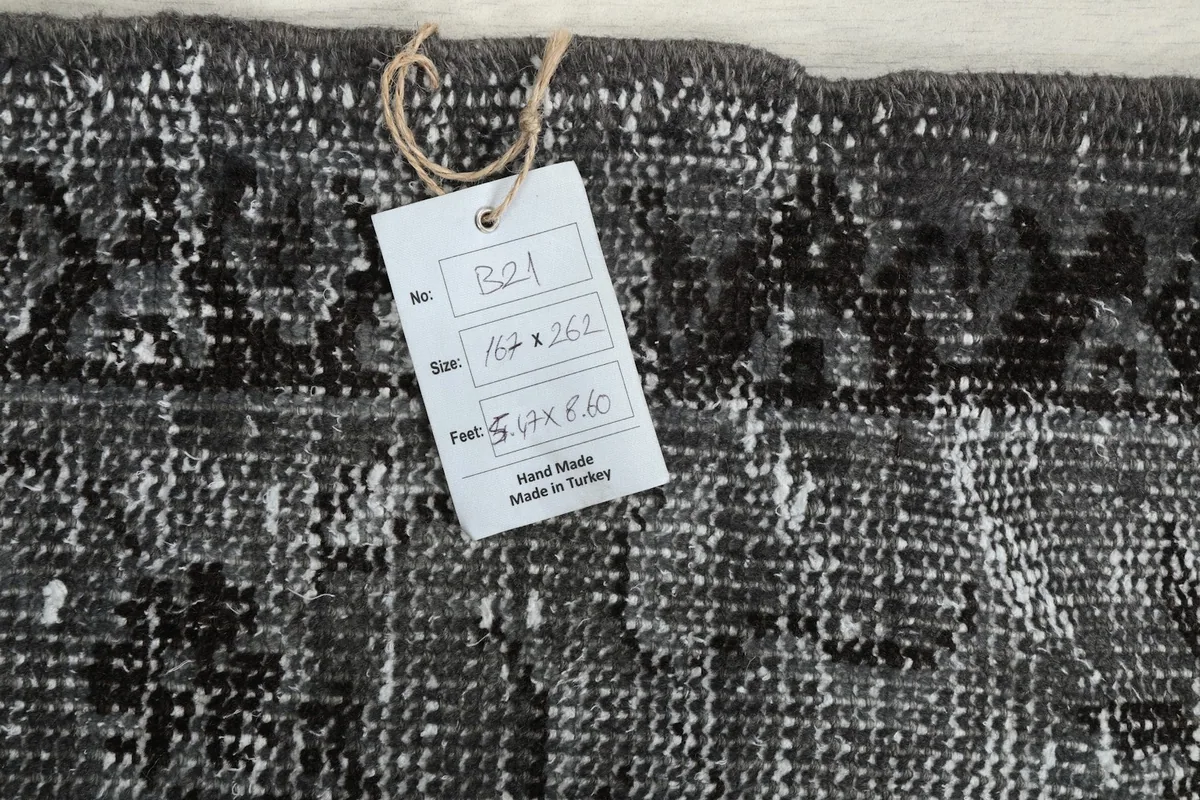 Tag showing the rug's dimensions 5'6" x 8'7" (167 x 262 cm) and origin from Turkey