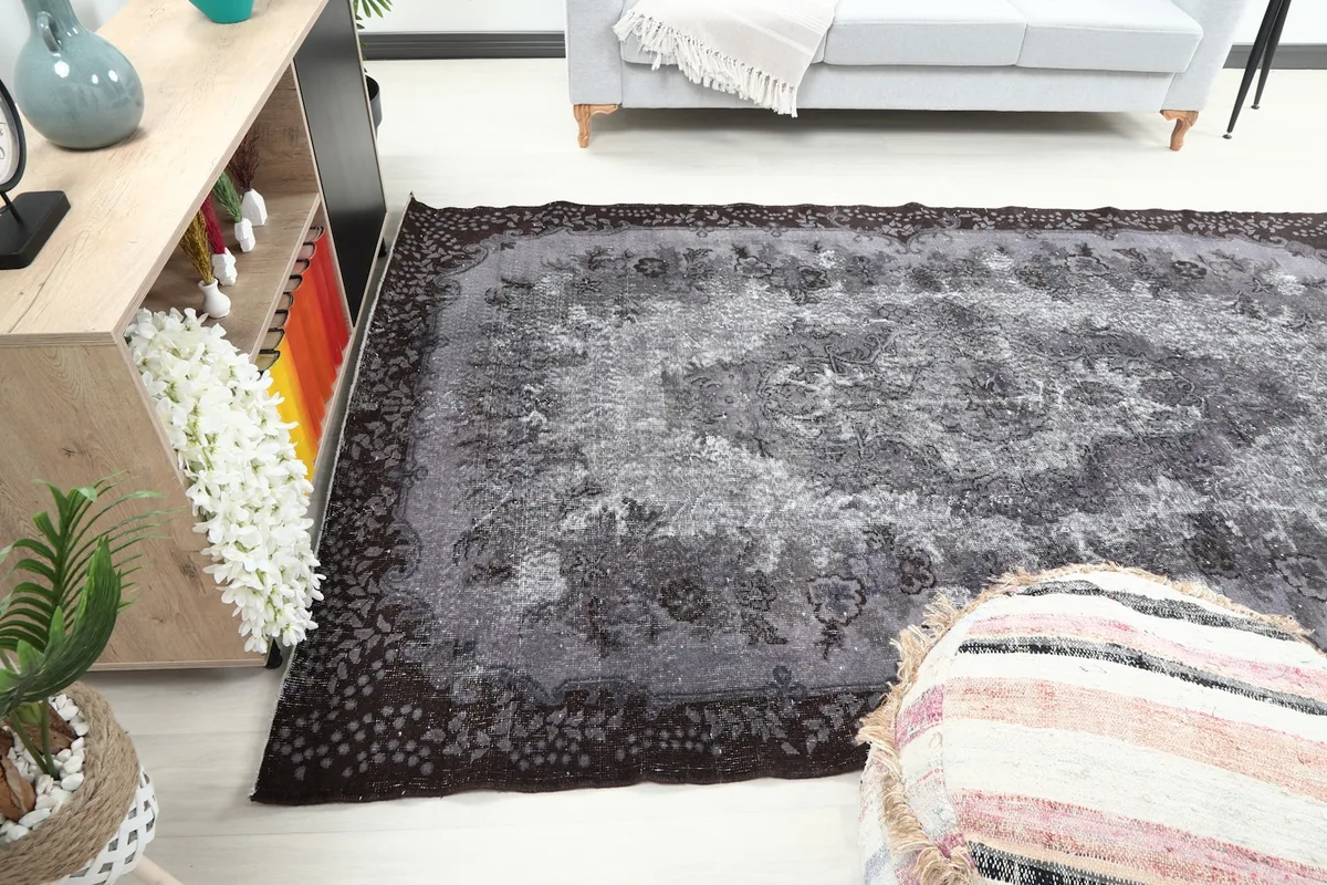Full room view of the rug from another angle, showcasing its size and colors