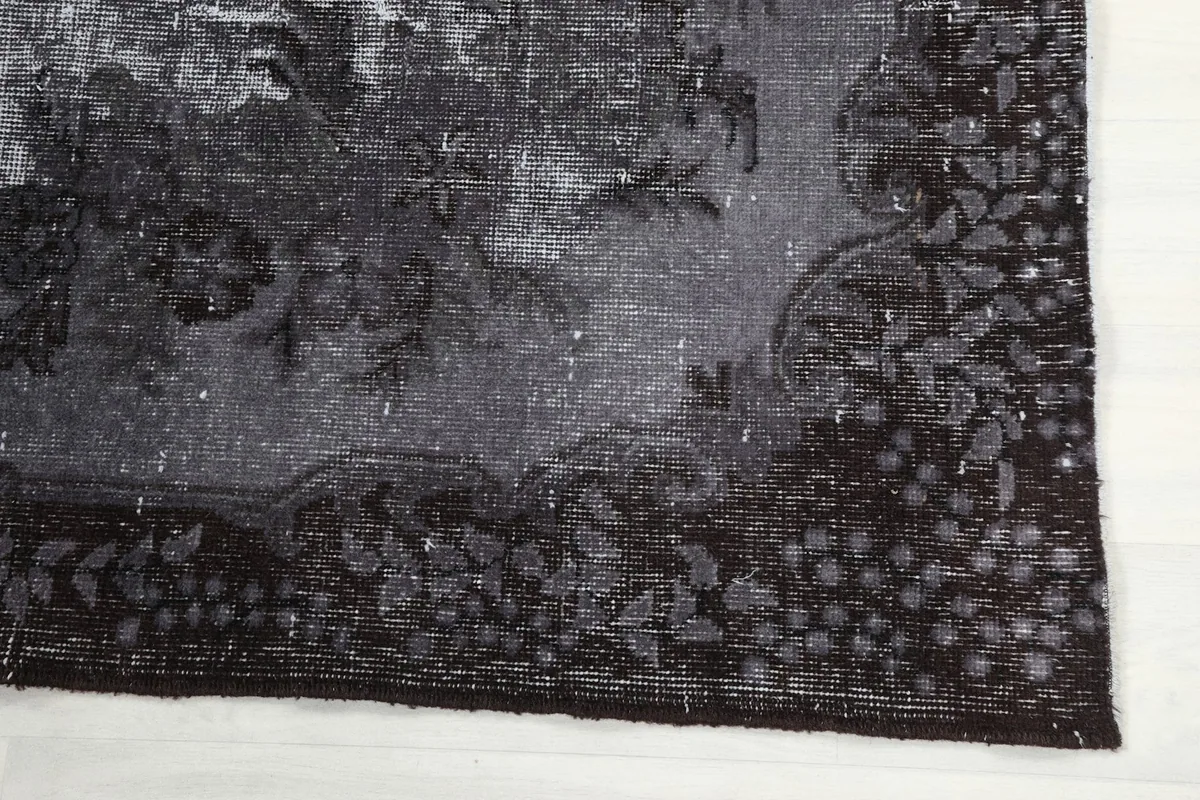 Corner detail of the charcoal border with intricate leaf patterns