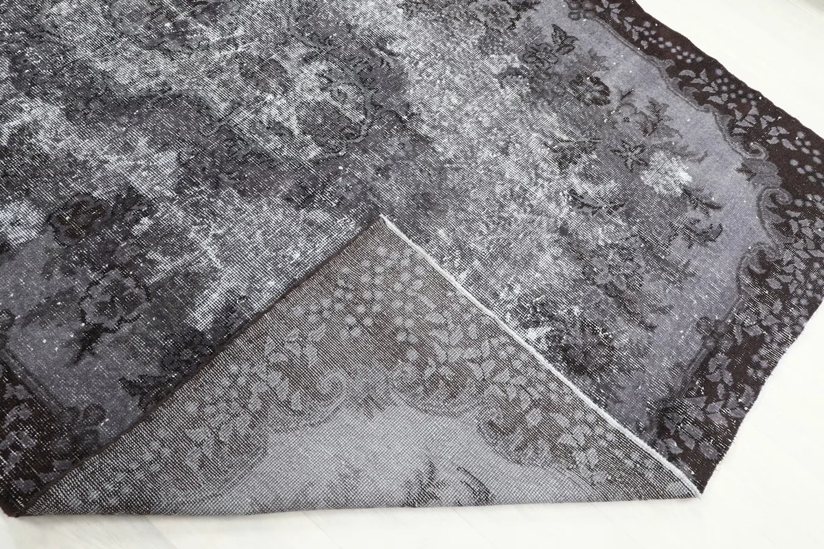 View of the rug's back, revealing the hand-knotted cotton foundation and wool knots