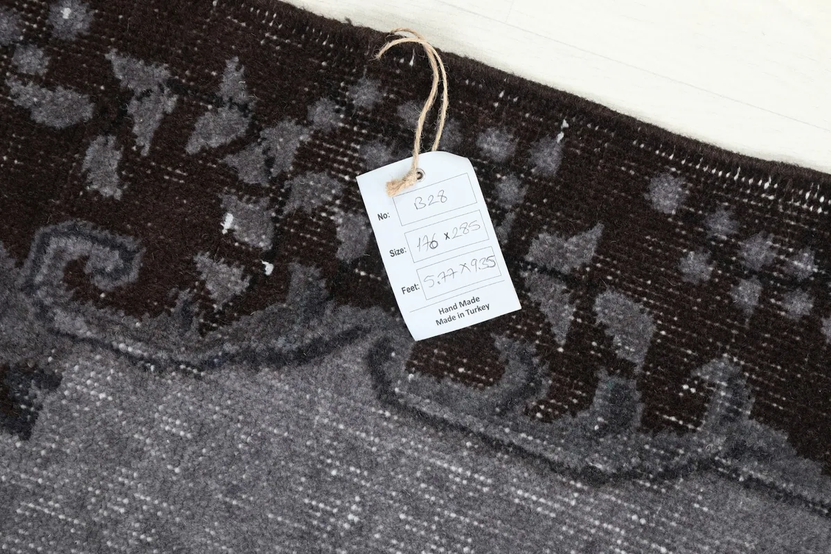 Tag on the rug showing size and origin details, indicating hand-made in Turkey