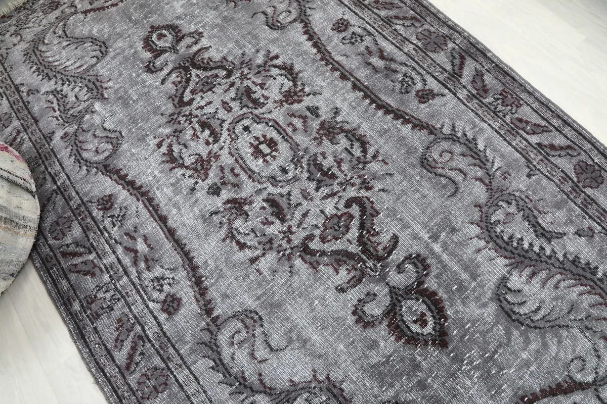 Detailed overhead view capturing the intricate design and color variations of the rug