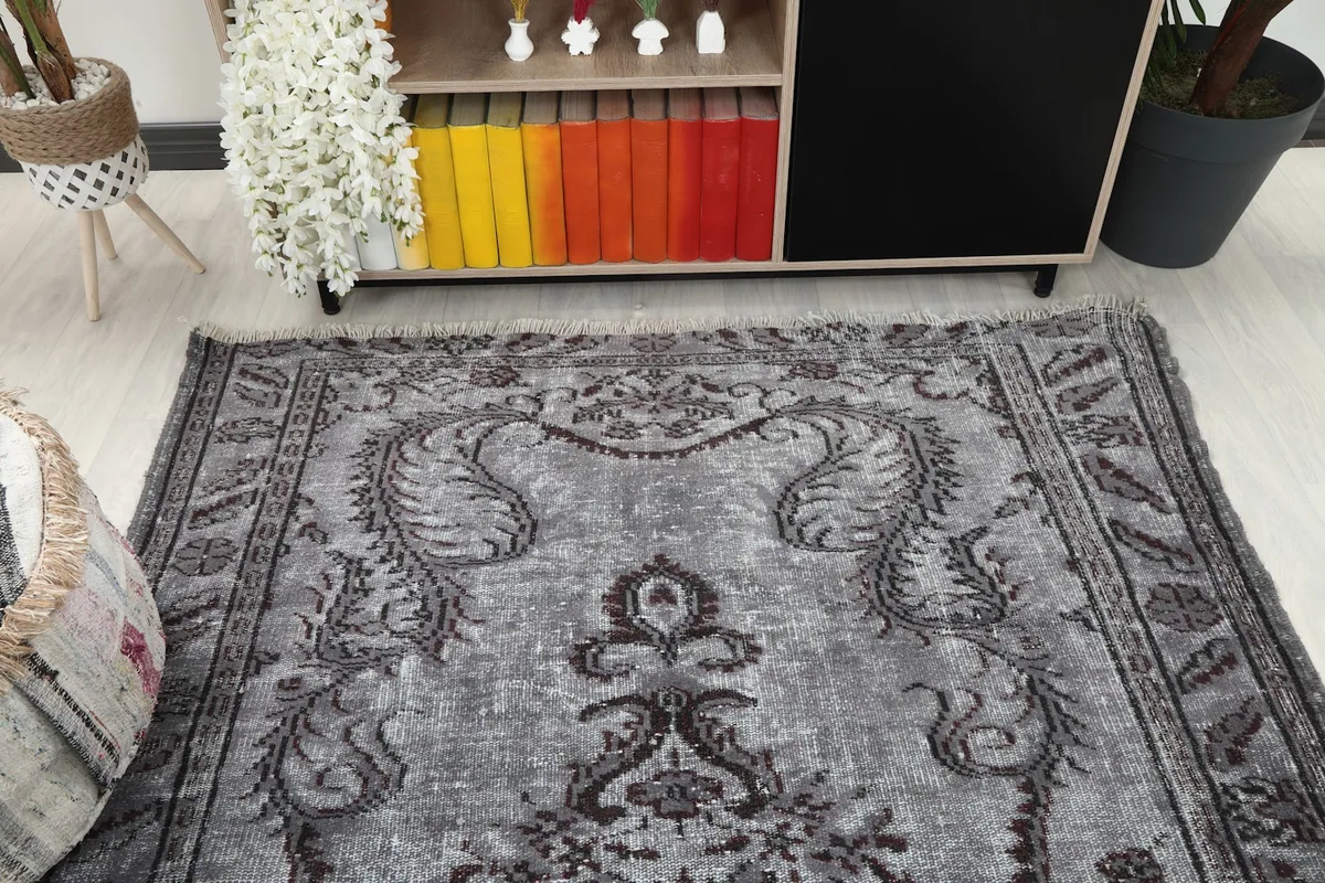 Top-down view of the vintage rug in a room, highlighting the central design