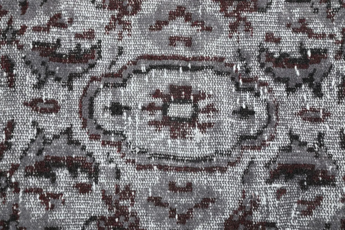 Extreme close-up of the hand-knotted wool pile showing texture and color blend