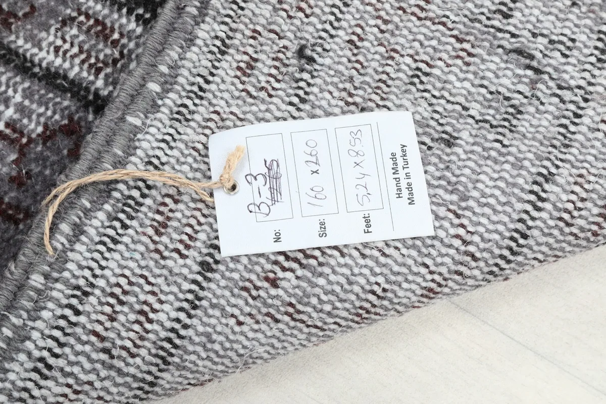 Product tag on the back of the rug displaying size and origin information