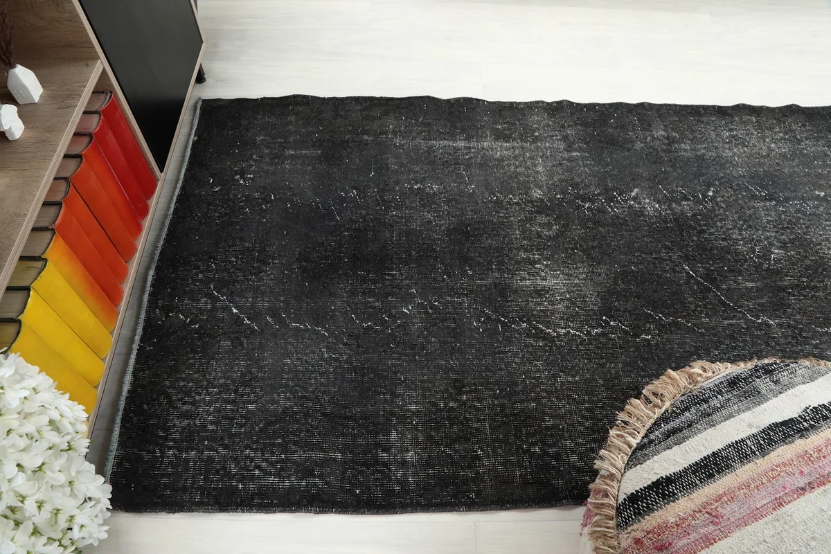 Elevated angle of the charcoal rug, capturing the full length and the distressed pattern.