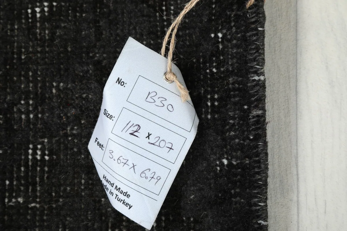 Tag displaying the rug's inventory number B30 and size 3'8" x 6'9" (112 x 207 cm).