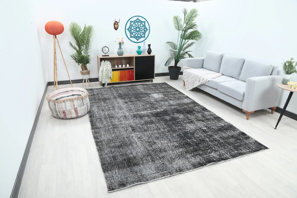 Wide view of the large charcoal rug complementing a modern living space