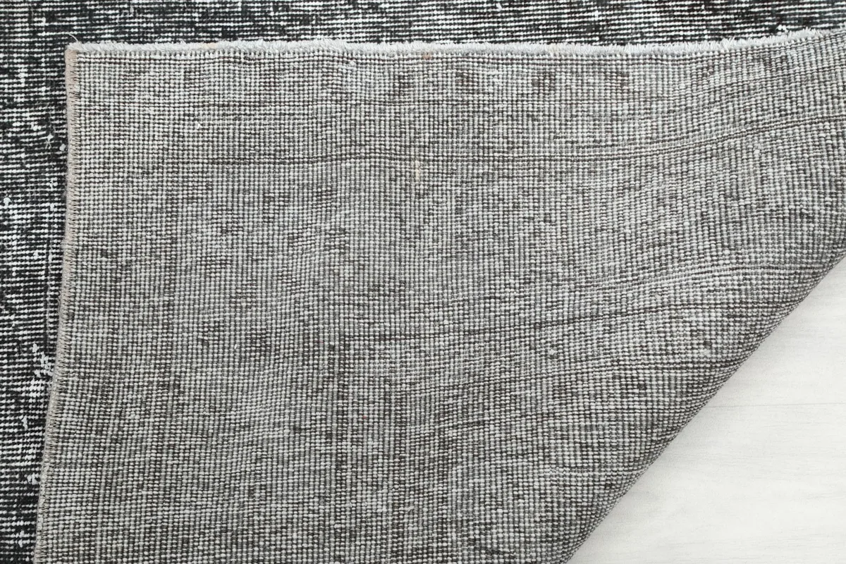 Close-up of the rug's reverse side, showcasing the knotting and foundation