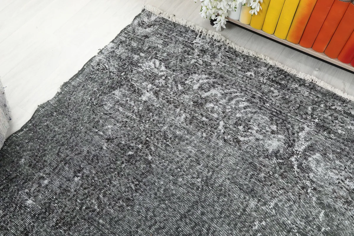 Overhead angle of the rug's corner, revealing subtle pattern remnants