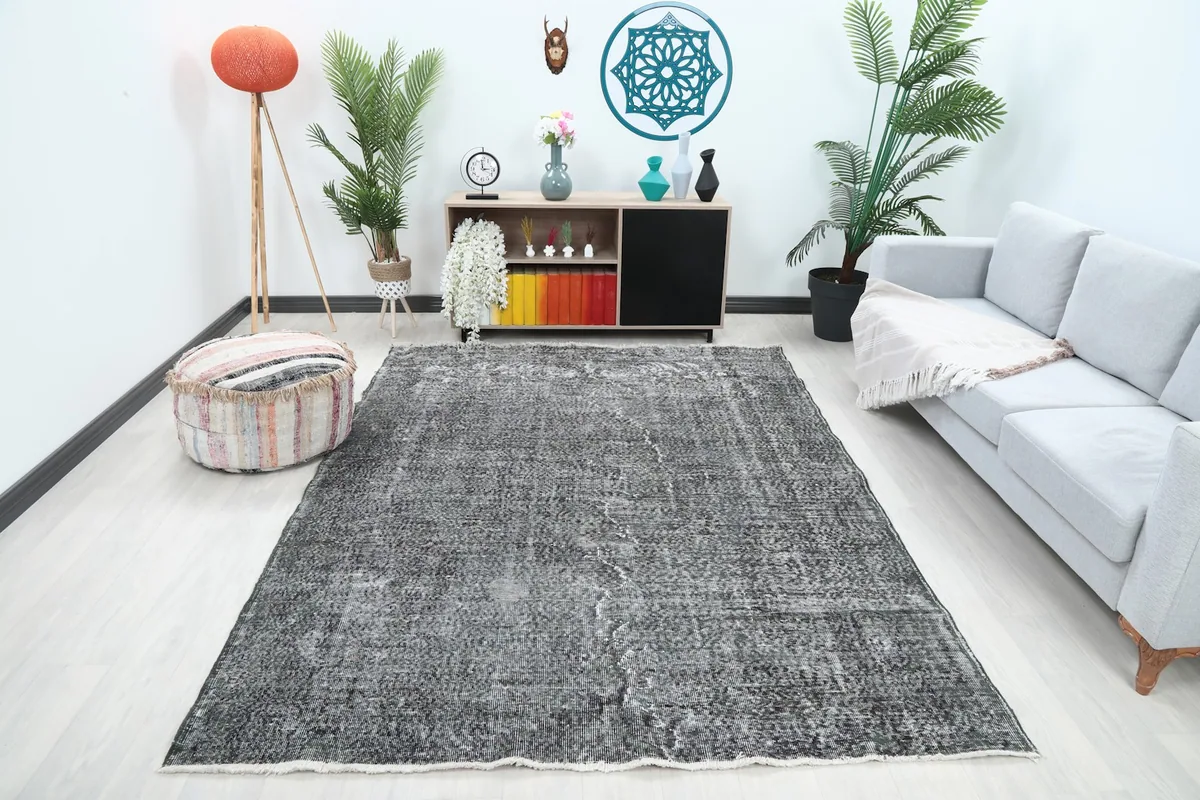Vintage charcoal rug centered in a modern living room setting