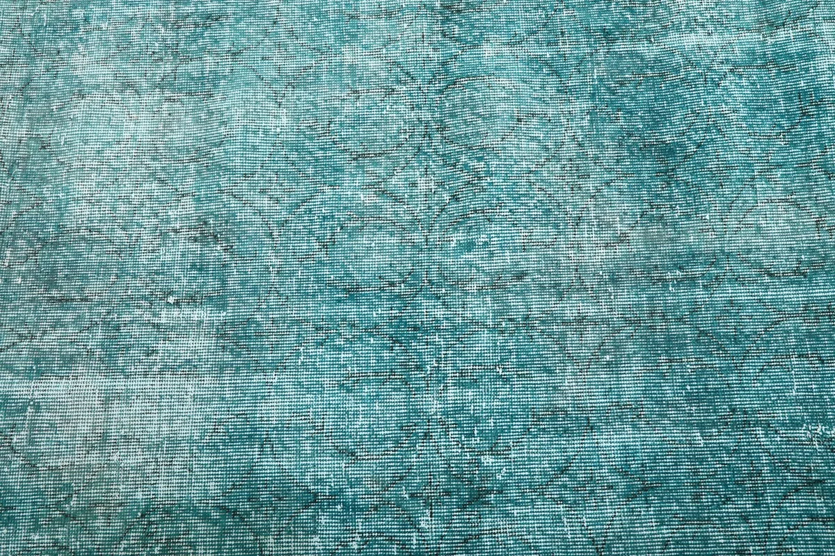 Close-up of the rug's pile, revealing the interwoven blue and gray tones and subtle patterns.