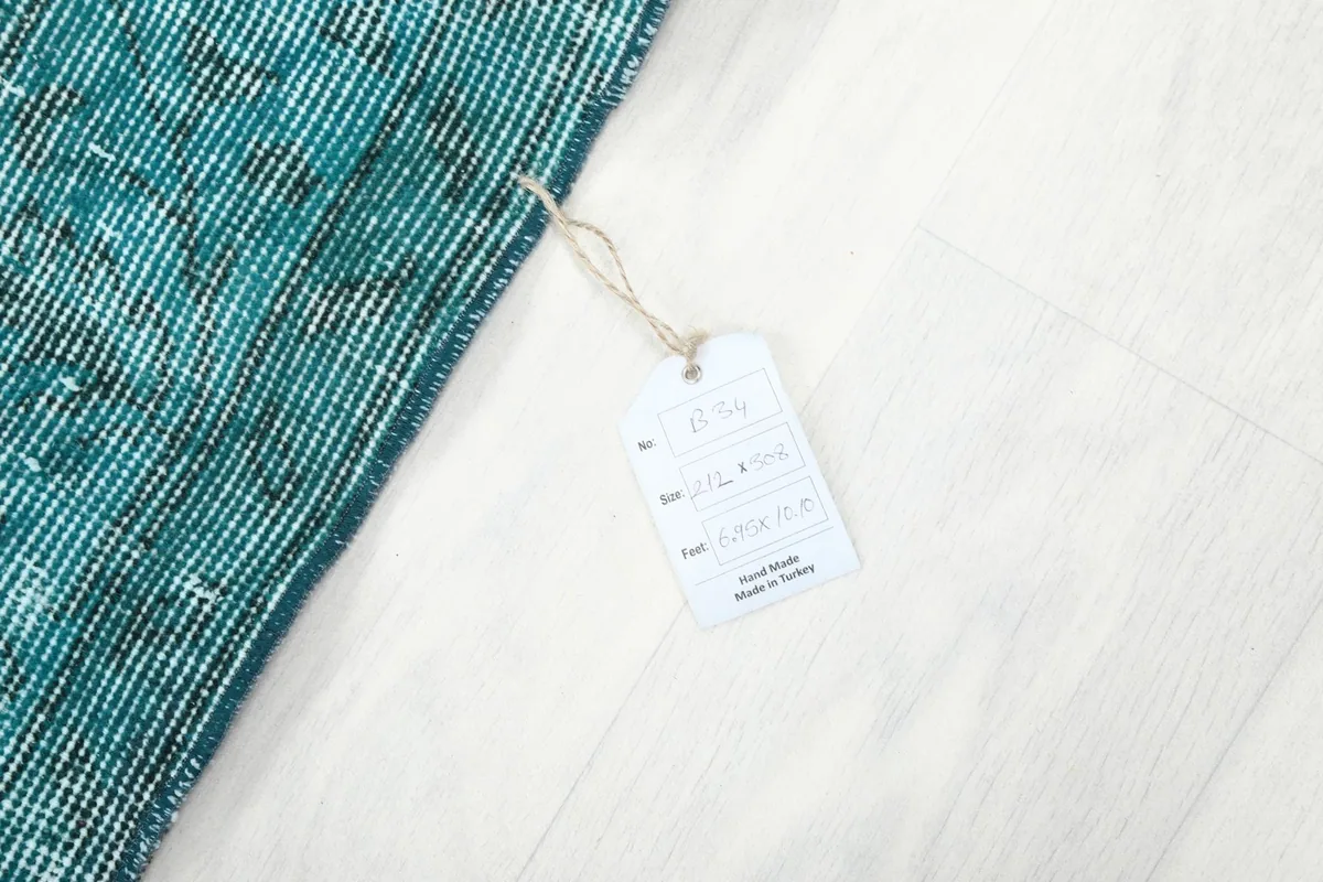 A product tag attached to the rug's corner, displaying size and origin details.