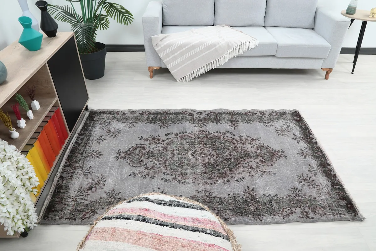 Full room view of the vintage rug, illustrating how it grounds the living area
