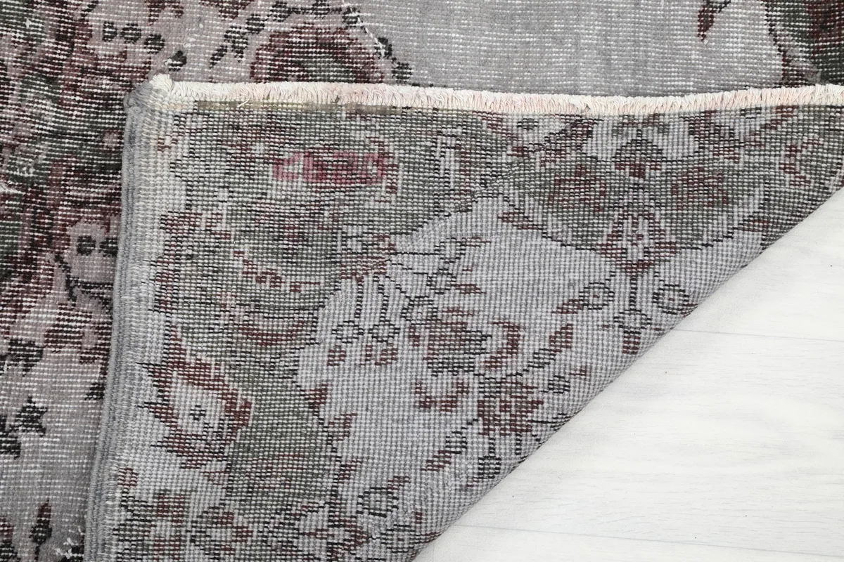 View of the rug's reverse side and fringe, revealing the hand-knotted construction