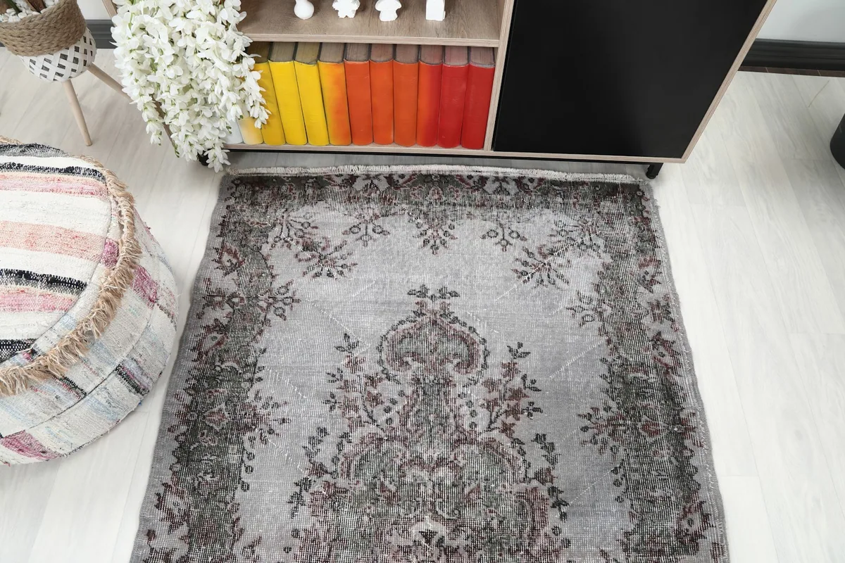 Overhead shot of the rug in a room, emphasizing its full pattern and color scheme