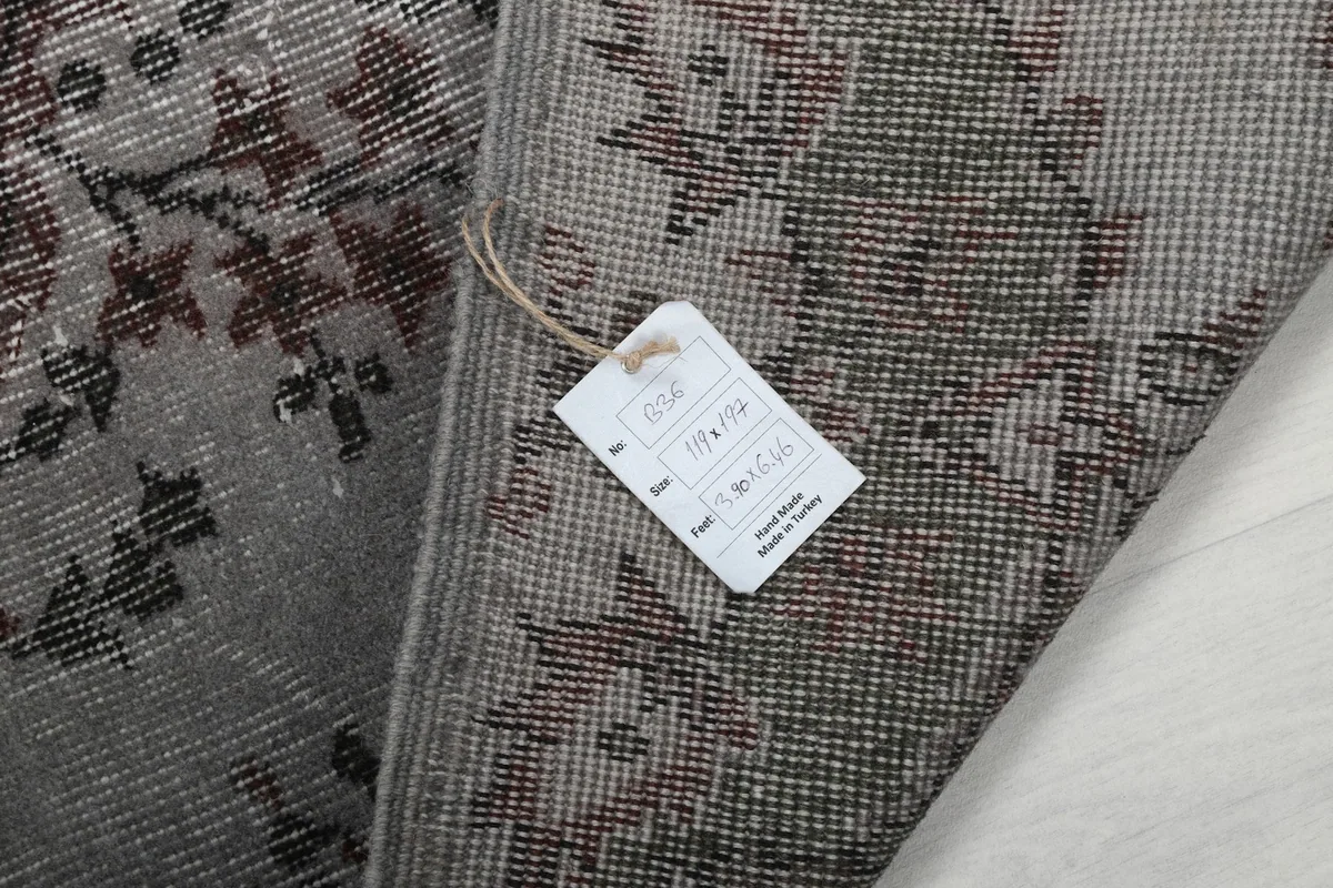 Close-up of the rug's label, indicating its origin and dimensions
