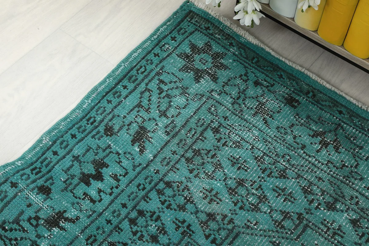 Corner detail of the rug, highlighting the geometric elements within the black border design