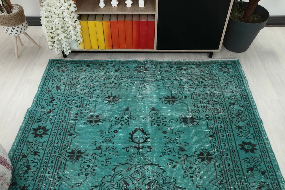 Overhead view of the blue and black rug in a room, showing its placement relative to furniture