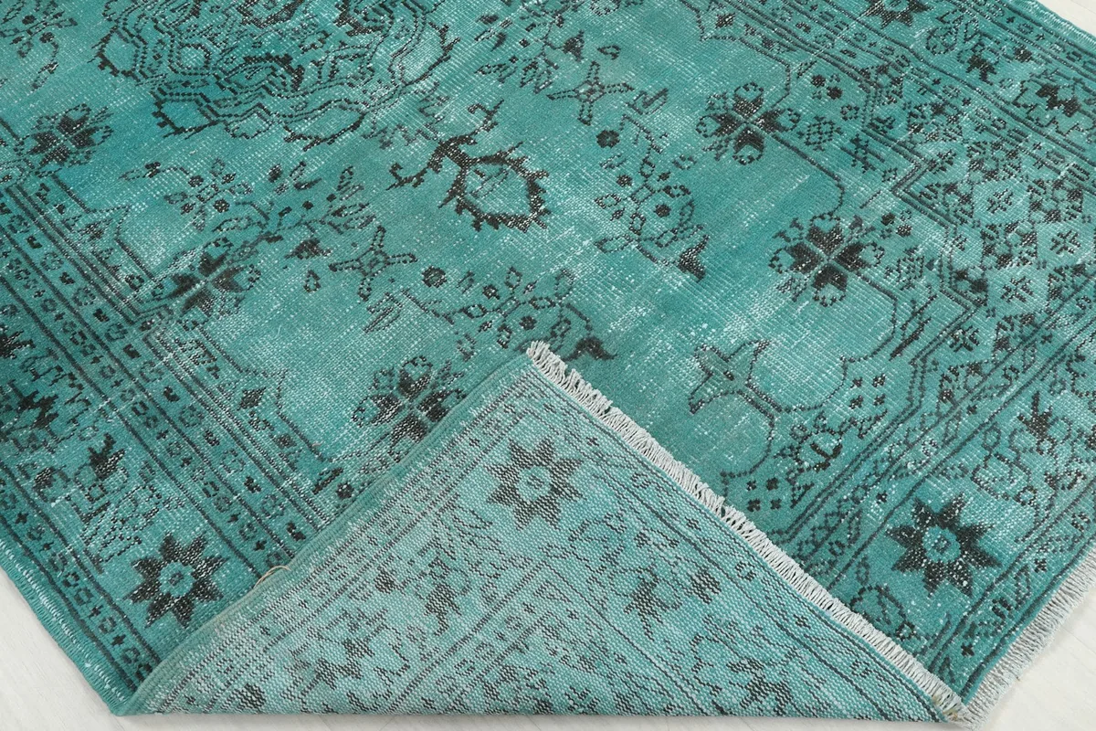 Folded corner of the rug, revealing the texture of the wool pile and cotton foundation