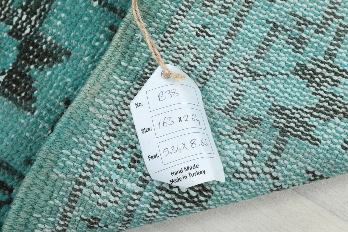 Product tag attached to the back of the rug, displaying its size and origin