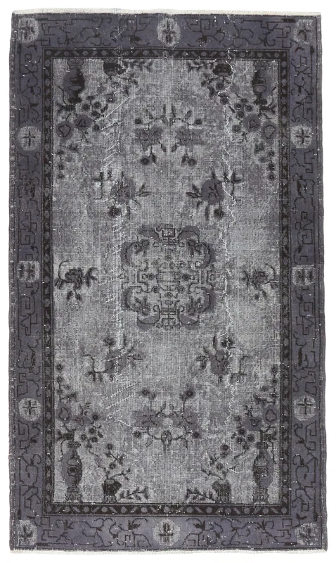 Full overhead view of the charcoal gray and gray vintage Anatolian rug on a white background