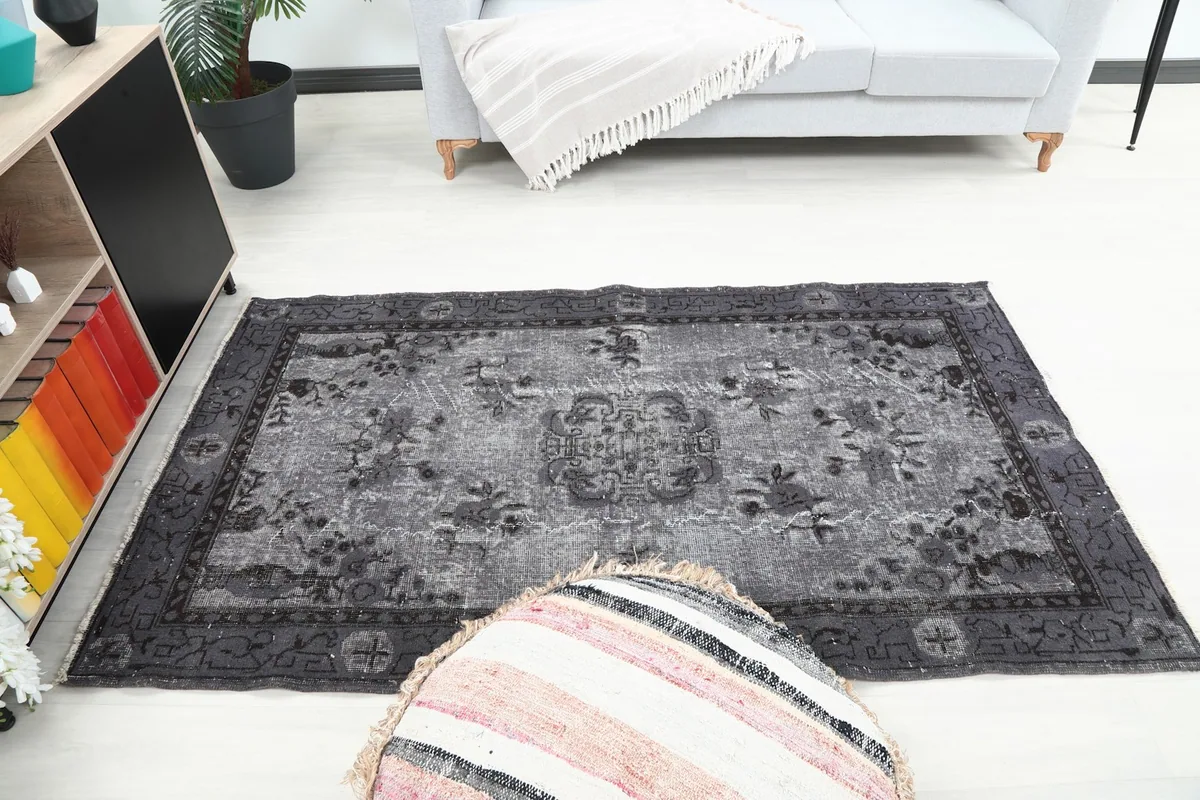 Wider room view of the charcoal gray rug, illustrating its size and placement in the space