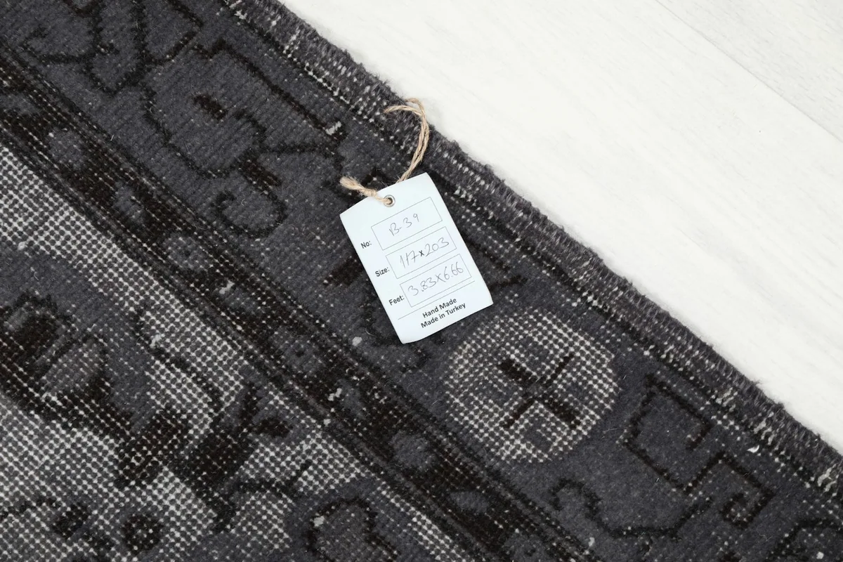Close-up of the product tag attached to the vintage Anatolian rug
