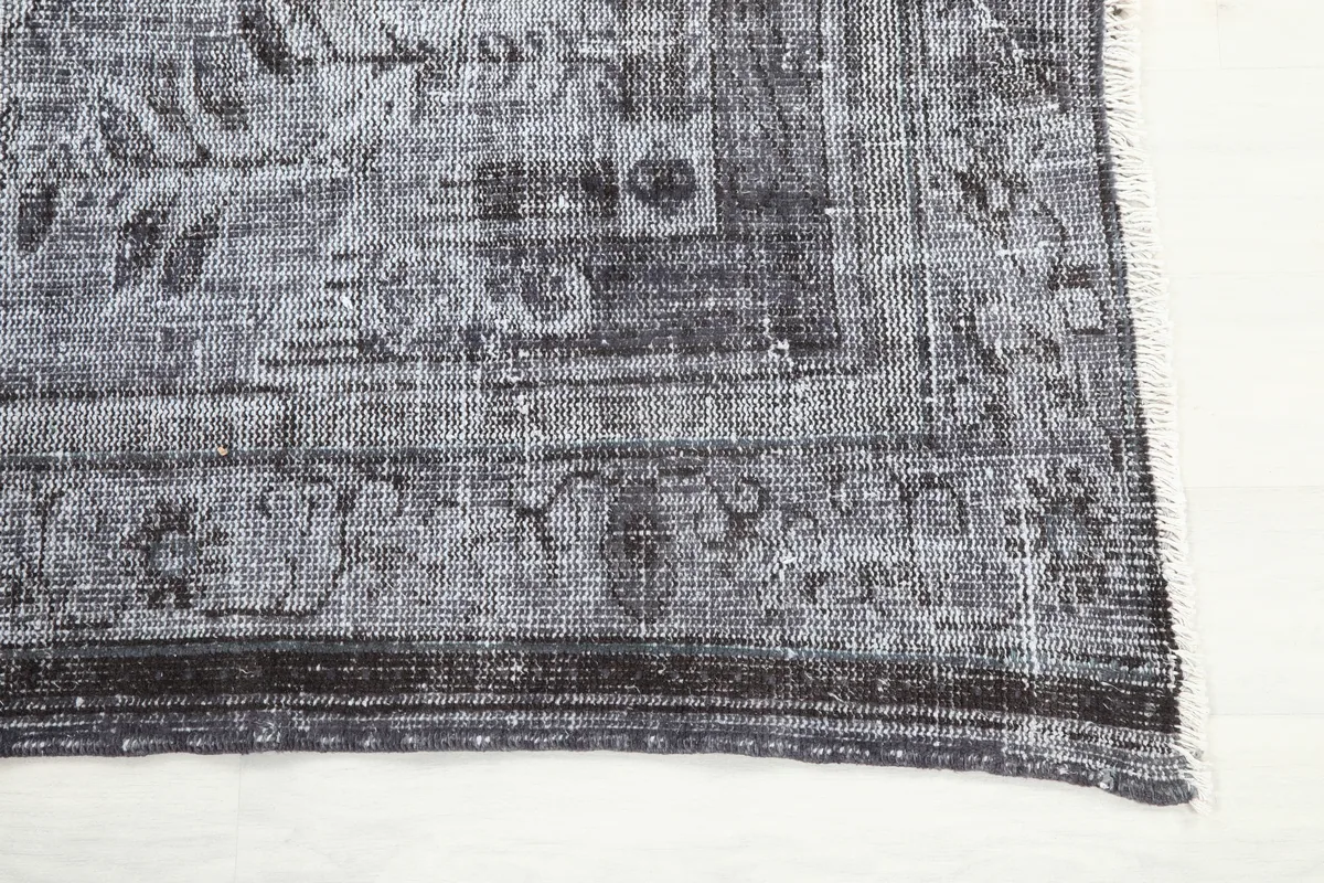 Detail of the Charcoal Medallion Anatolian Rug's border design and fringe