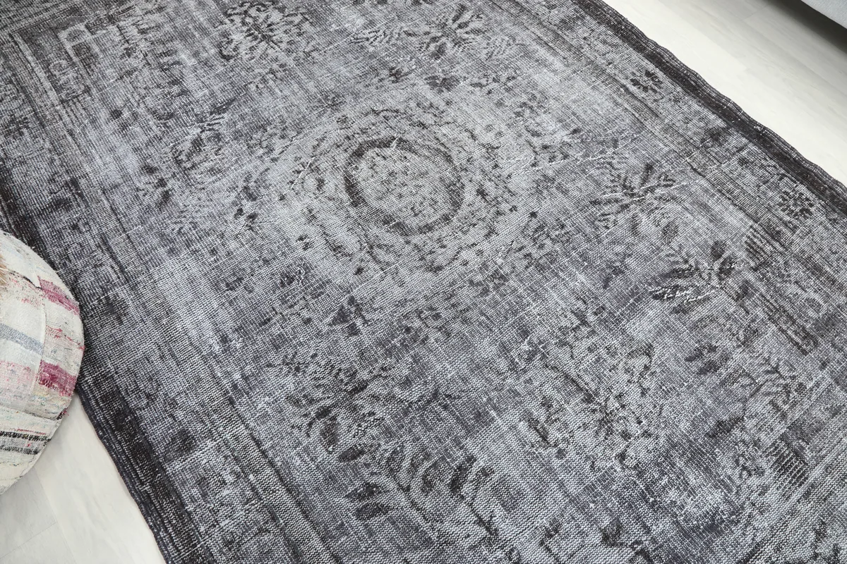Close-up of the Charcoal Medallion Anatolian Rug's central medallion and faded motifs