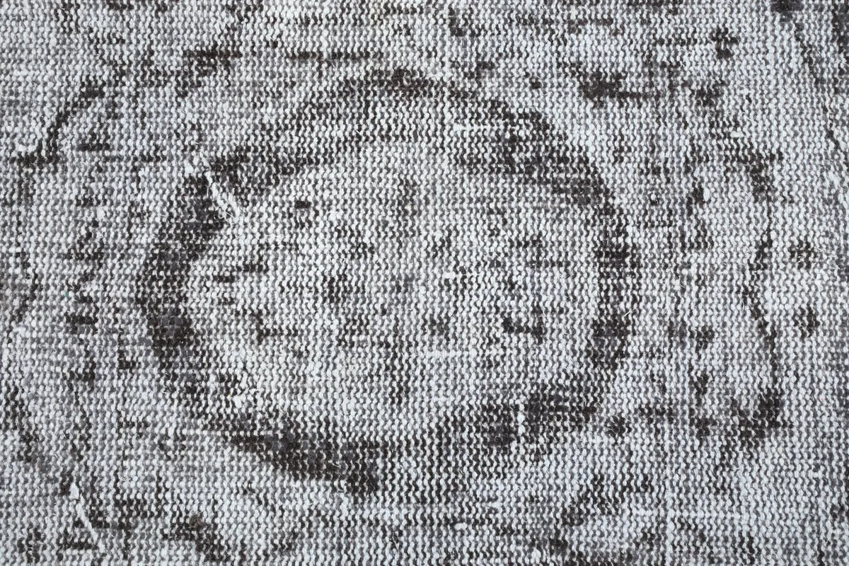 Detailed view of the low pile and hand-knotted texture of the Charcoal Medallion Anatolian Rug