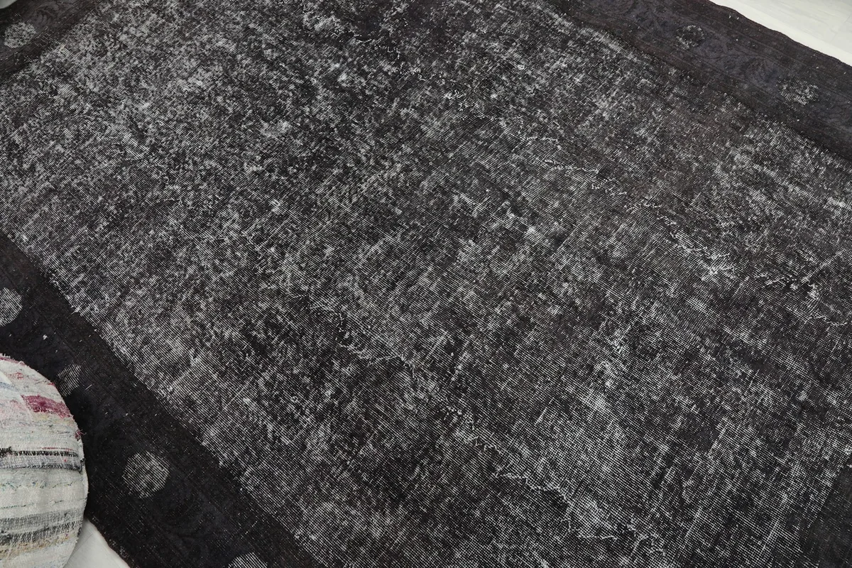 Angled view of the rug's surface, highlighting the blend of charcoal and gray tones.
