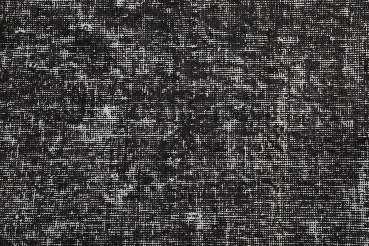 Close-up detail of the hand-knotted wool pile and its varied texture.