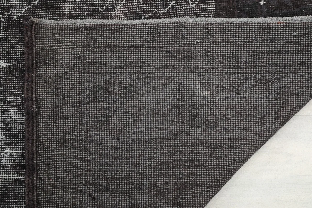 Close-up of the rug's backing, revealing the hand-knotted construction.